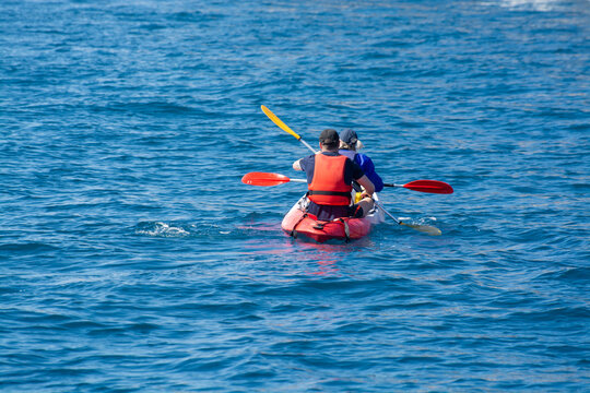 Unidentified sporters in kayak is Calanque de Port-Miou near Cassis, excursion to Calanques national park in Provence, France