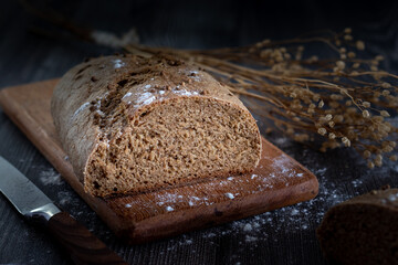 Cut loaf of homemade bread on a wooden board