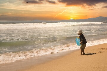 Fototapeta na wymiar a kid walking on the beach