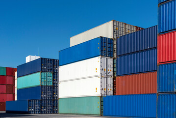 Fototapeta premium shipping containers stacked and stored in a container yard: Logistics industry 
