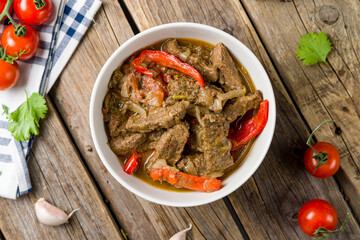 chashushuli with veal and vegetables georgian kitchen top view on wooden table