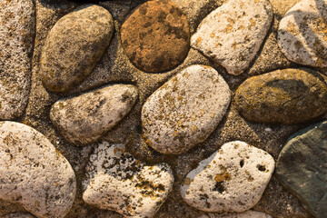 The pattern on the floor of light and dark pebbles. Modern mosaic of natural material.