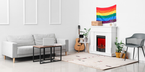 Interior of modern living room with sofa, fireplace and LGBT flag