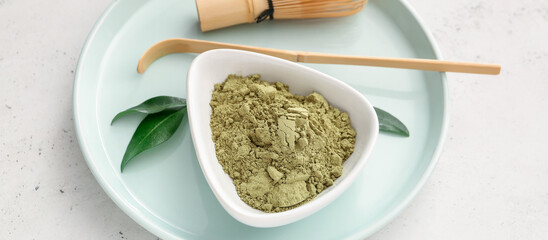 Tray with powdered matcha tea on light background