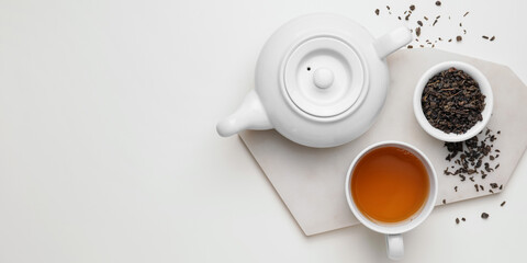 Obraz na płótnie Canvas Teapot, cup of tea and dry leaves in bowl on white background with space for text