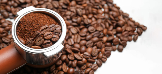 Portafilter with coffee powder and beans, closeup