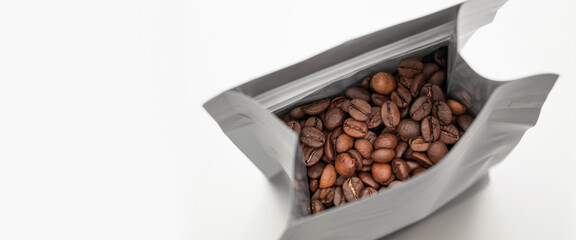 Bag of coffee beans on white background with space for text