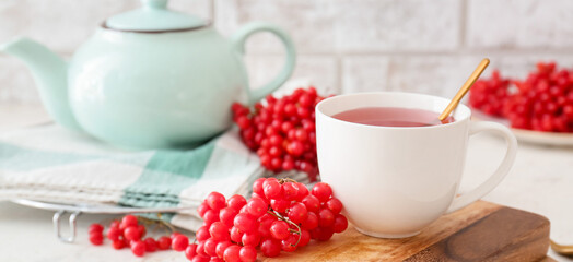 Cup of healthy viburnum tea on table