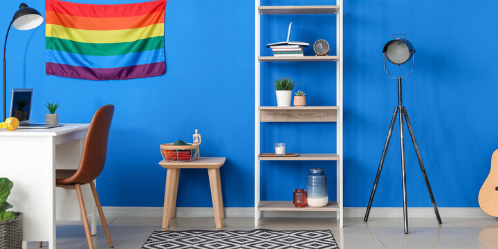 Interior of modern room with rack, workplace and LGBT flag