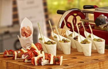 A stall in the outdoor market in Prague offering decorated canapés, small sandwiches, skewers of...