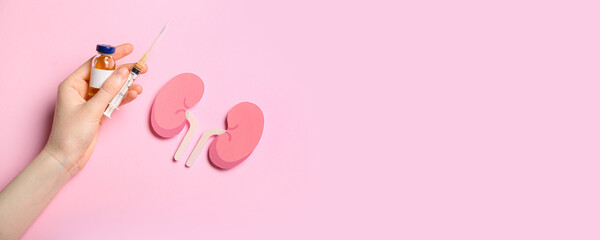 Hand, drugs and paper kidneys on pink background with space for text