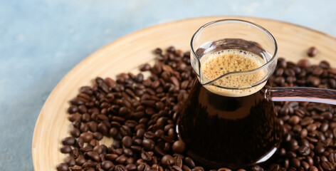 Jezve with delicious turkish coffee and plate of beans on color background