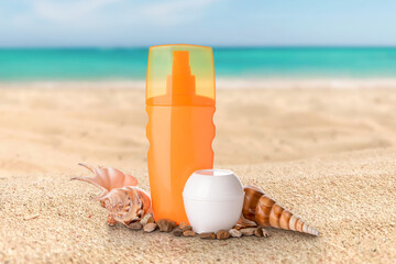Fototapeta na wymiar Sunscreen creams and seashells on beach sand