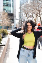 Portrait of happy young girl smiling looking at camera on city street