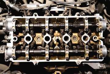 Disassembled car engine. Cylinder head of an automobile engine. Repaired car inside. Sixteen...