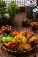 Traditional food from Indonesia with iced tea on a wooden table. Front View.
