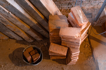 Fototapeta na wymiar Bucket with red ceramic bricks. Warehouse of bricks at a construction site. concrete blocks