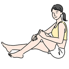 座って足を触っているスタイルのいい若い女性