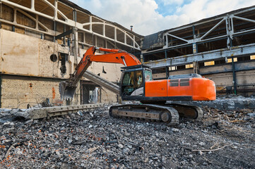 Hydraulic excavators at demolition site of industrial complex