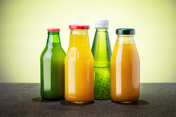 Glass bottles of various fruit juices. Summer drinks.
