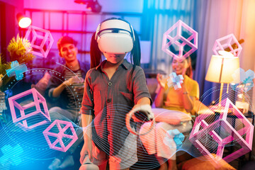 vr technology entertainment at home concept.asian child girl enjoy metaverse gaming with wearable vr headset with control handle playing sport gaming online in living room at home