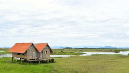 Obraz premium Abandoned house with orange roof located in Thale Noi area the part of Songkhla Lake, Phatthalung, THAILAND.