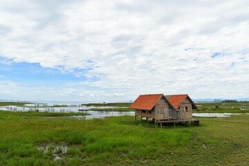 Abandoned house with orange roof located in Thale Noi area the part of Songkhla Lake, Phatthalung, THAILAND.
