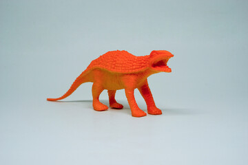 Side view of plastic Ankylosaurus dinosaur plastic toy for kids, isolated on a studio lighting...