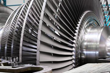 Fototapeta Rotor with blades of powerful steam turbine in workshop obraz