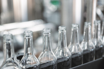 Row of glass bottles to fill with expensive alcohol drinks