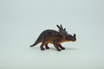 Side view of plastic Triceratops dinosaur plastic toy for kids, isolated on a studio lighting...
