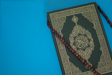 Closeup shot of Koran book cover with arabic calligraphy that means the Holy Quran.Book of GOD with...
