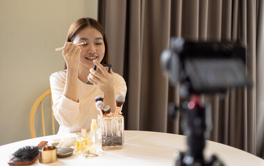 young beauty Asian blogger show make up in front of camera record. Concept for new career and social media influencer