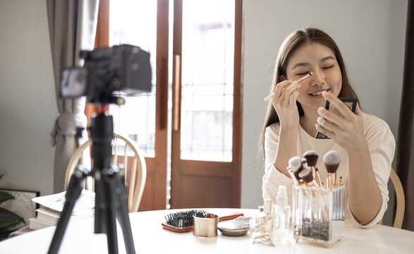 young beauty Asian blogger show make up in front of camera record. Concept for new career and social media influencer