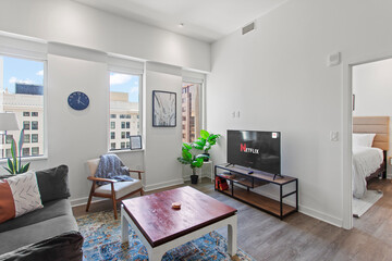 modern interior of a white apartment with open floor layout long term rental loft