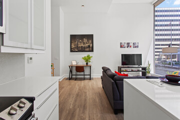 beautiful kitchen in new luxury home with island, pendant lights, hardwood floors, and stainless steel appliances
