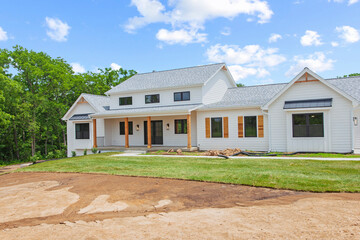 Fototapeta na wymiar Brand new construction farmhouse style white home exterior