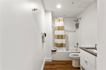 Interior of bathroom with striped shower curtain