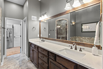 interior of bathroom with granite counter tops and mirror