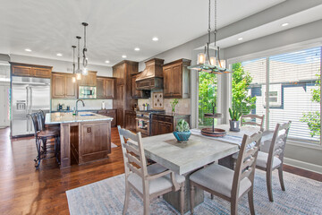 larger kitchen with granite countertops, floor to ceiling cabinets and hardwood floors