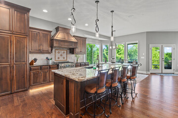 larger kitchen with granite countertops, floor to ceiling cabinets and hardwood floors