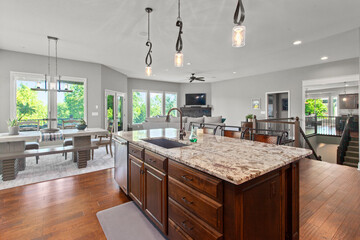 larger kitchen with granite countertops, floor to ceiling cabinets and hardwood floors