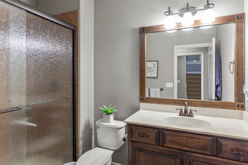 interior of bathroom with granite counter tops and mirror