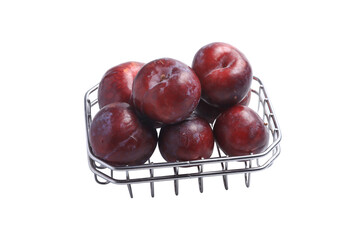 Fresh plum in a basket on a white background, unretouched.