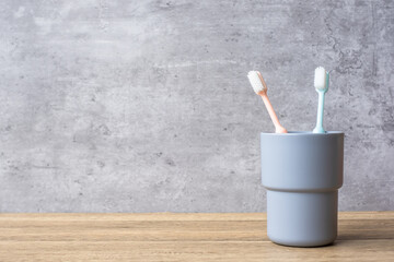 Set of Toothbrushes in cup on wall background at bathroom. World oral health day and free dental day concept