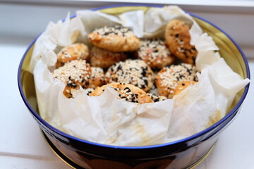Turkish salted cookies with black sesame in box. It is called "Tuzlu Kurabiye", "Kuru Pasta", "Kandil Simidi" in Turkish. Homemade Pastry.