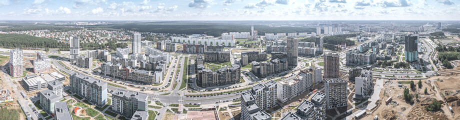 Fototapeta na wymiar aerial panoramic view of new urban residential district with apartment buildings and roads
