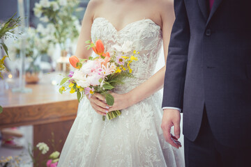 Bride holding bouquet and groom together