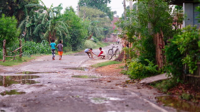 rural boy playing at street image