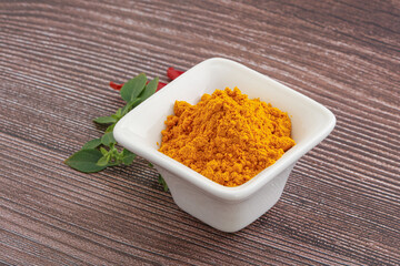 Yellow vibrant curcuma powder in the bowl